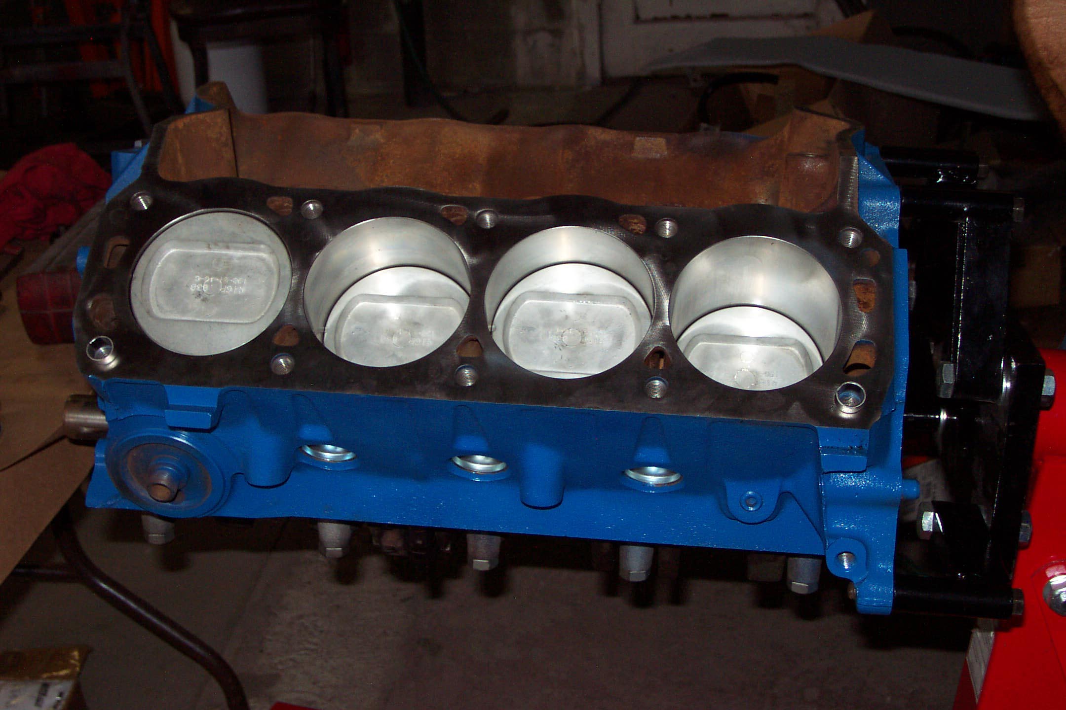 newengineblockwithpistonsinstalled2ndphaserestoration.jpg